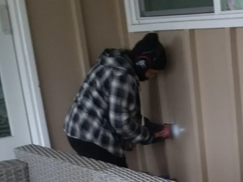 Professional electrician installing an exterior outlet in Independence